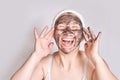 Young woman applying black face mask. Charcoal facial product. Acne and pimple Royalty Free Stock Photo