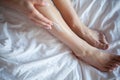 Young woman applying body lotion on legs Royalty Free Stock Photo