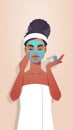 Young woman applying clay face mask dressed in towel african american girl skincare spa facial treatment concept