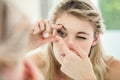 Young woman applying contact lens Royalty Free Stock Photo