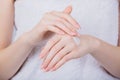 Young woman applying cream on her hand. Woman moisturizing hand with cosmetic cream lotion Royalty Free Stock Photo