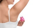 Young woman applying deodorant to armpit on background, closeup Royalty Free Stock Photo