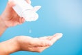 Young woman applying drop dispenser sanitizer alcohol gel on hand