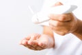 Young woman applying drop dispenser sanitizer alcohol gel on hand