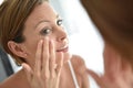 Young woman applying facial cream Royalty Free Stock Photo