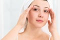 Young woman applying facial cream Royalty Free Stock Photo