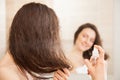 Young woman applying hair spray Royalty Free Stock Photo