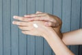 Young woman applying hands cream