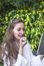 A young woman applying a lipstic