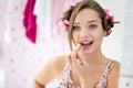 Young woman applying lipstick in bathroom Royalty Free Stock Photo