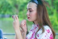 Young woman applying lipstick looking at mirror Royalty Free Stock Photo