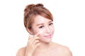 Young woman applying moisturizer cream on face Royalty Free Stock Photo