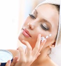 Young Woman Applying Moisturizing Cream Royalty Free Stock Photo