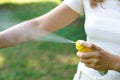 Young woman applying mosquito repellent on her arm during hike in nature. Insect repellent. Skin protection against tick and other Royalty Free Stock Photo