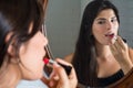 Woman applying red lipstick in bathroom Royalty Free Stock Photo