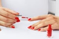 Young woman applying red nail polish on her fingers. Manicure. Red nails Royalty Free Stock Photo