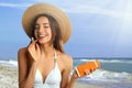 Woman applying sun protection cream at beach Royalty Free Stock Photo