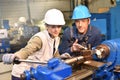Young woman apprentice learning metallurgic work Royalty Free Stock Photo