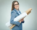 Young woman architect wearing glasses holding paper blueprints. Royalty Free Stock Photo