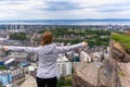 Young woman with arms raised on a hill over the city of Edinburgh Royalty Free Stock Photo