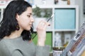 Young woman artist in her studio contemplating with attention her work while doing it. Selective focus Royalty Free Stock Photo