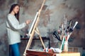 Young woman artist painting at home creative tools close-up