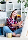 Beautiful woman artist painting a picture at home