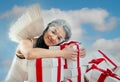 Young woman as angel with heap of gift boxes Royalty Free Stock Photo