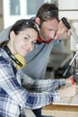 Young woman as apprentice in wood construction Royalty Free Stock Photo