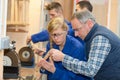 young woman as apprentice in wood processing at guitar workshop Royalty Free Stock Photo