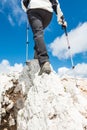 Young woman ascending a mountain ridge