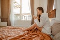 Young woman asia living at home relaxing and drinking cup of hot coffee in the bedroom on holiday. Royalty Free Stock Photo