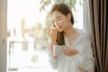 Young woman asia living at home relaxing and reading a book in the bedroom on holiday Royalty Free Stock Photo