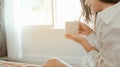 Young woman asia living at home relaxing and reading a book in the bedroom on holiday Royalty Free Stock Photo