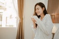 Young woman asia living at home relaxing and reading a book in the bedroom on holiday Royalty Free Stock Photo