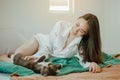 Young woman asia wake up refreshed in the morning playing with cats at bed happily on holiday. Royalty Free Stock Photo