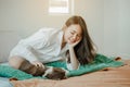 Young woman asia wake up refreshed in the morning playing with cats at bed happily on holiday. Royalty Free Stock Photo