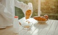 Young woman asia wake up refreshed in the morning and relaxing eat coffee, cornflakes, bread and apple for breakfast at house on h Royalty Free Stock Photo