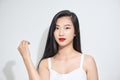 Young woman Asian appearance with black hair stands isolated white background in Studio