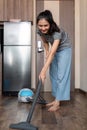 Young woman asian cleaning floor with vacuum cleaner in living room, Housework, cleanig and chores concept Royalty Free Stock Photo