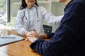 young woman Asian doctor patient, patting shoulder with care, support, sympathy, hope, giving comfort, empathy, asking Royalty Free Stock Photo