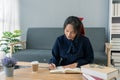 Young woman of Asian write down memories in notebook diary, work homework Royalty Free Stock Photo