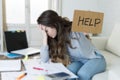 Young woman asking for help suffering stress doing domestic accounting paperwork bills Royalty Free Stock Photo
