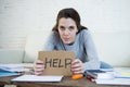 Young woman asking for help suffering stress doing domestic accounting paperwork bills Royalty Free Stock Photo