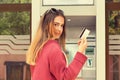 Young woman at the ATM cash point machine showing credit card looking g at you camera Royalty Free Stock Photo