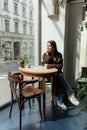 young woman in autumn coat sitting Royalty Free Stock Photo