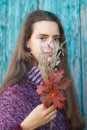 Portrait of a pretty young teenage girl 13-16 years old. Young woman with autumn flowers closeup Royalty Free Stock Photo