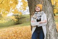 Young woman in autumn leaves and fall yellow maple garden background Royalty Free Stock Photo