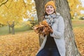 Young woman in autumn leaves and fall yellow maple garden background Royalty Free Stock Photo