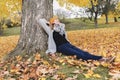 Young woman in autumn leaves and fall yellow maple garden background Royalty Free Stock Photo